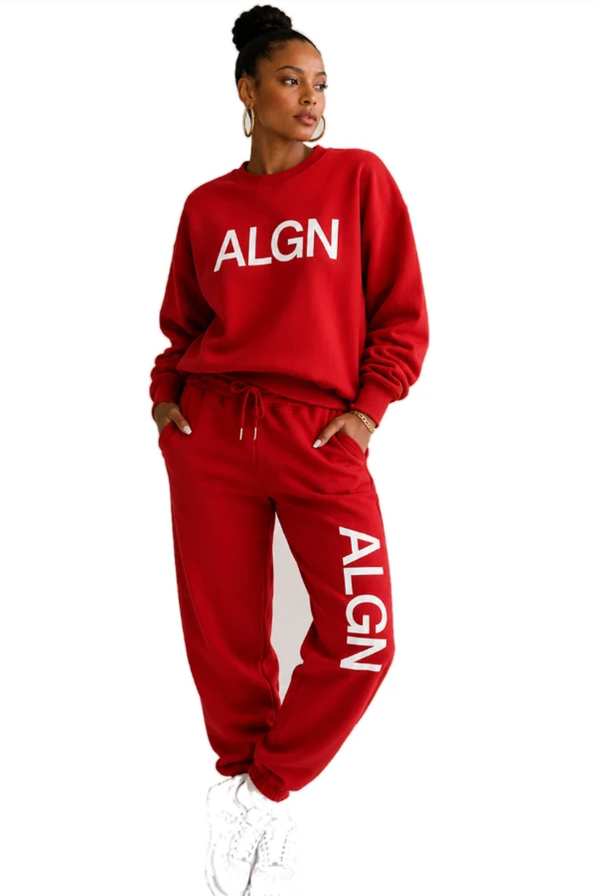 A woman wearing the black and white ALGN Signature sweatshirt and sweatpants set